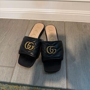 Gucci Black Mules with Gold Logo